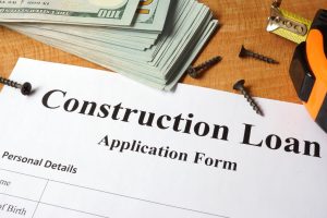 Construction loan form on a wooden table.